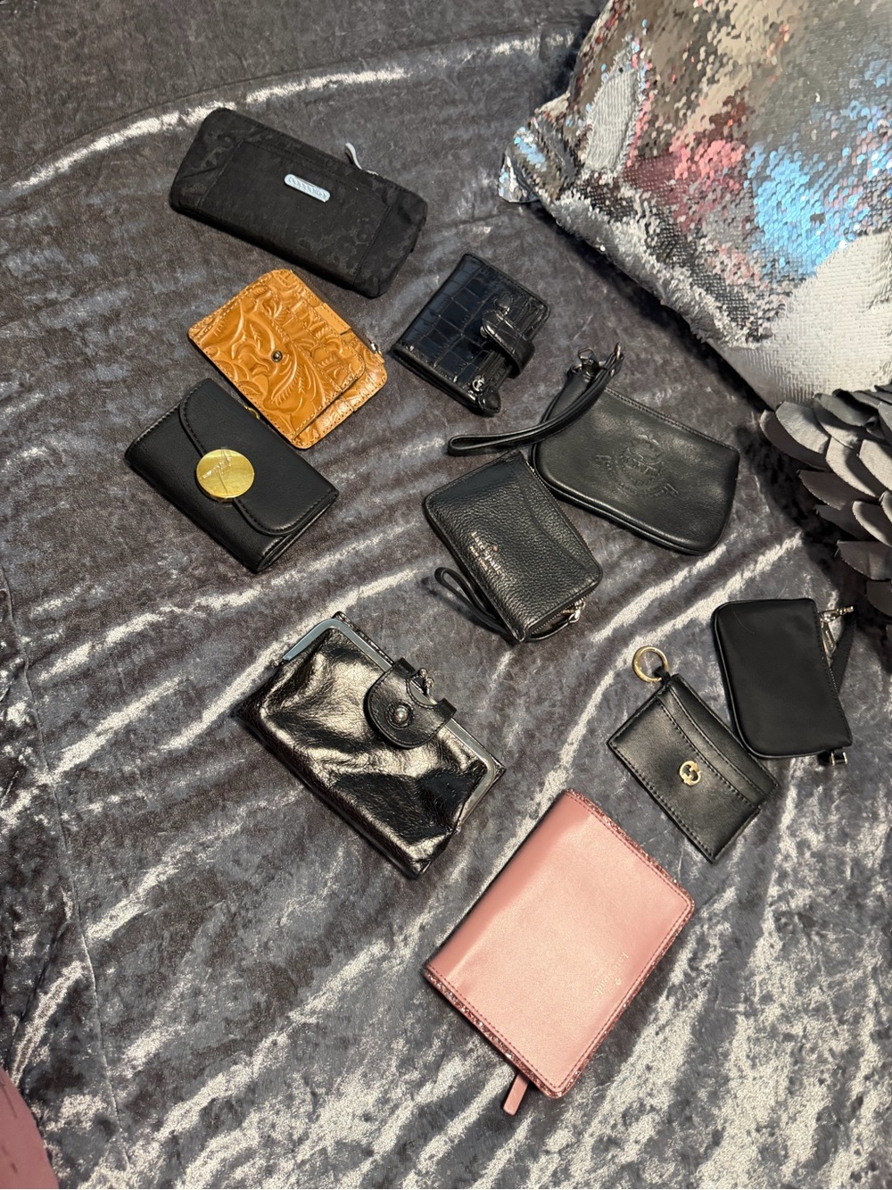 Assortment of women's wallets and small pouches in various styles, colors, and m